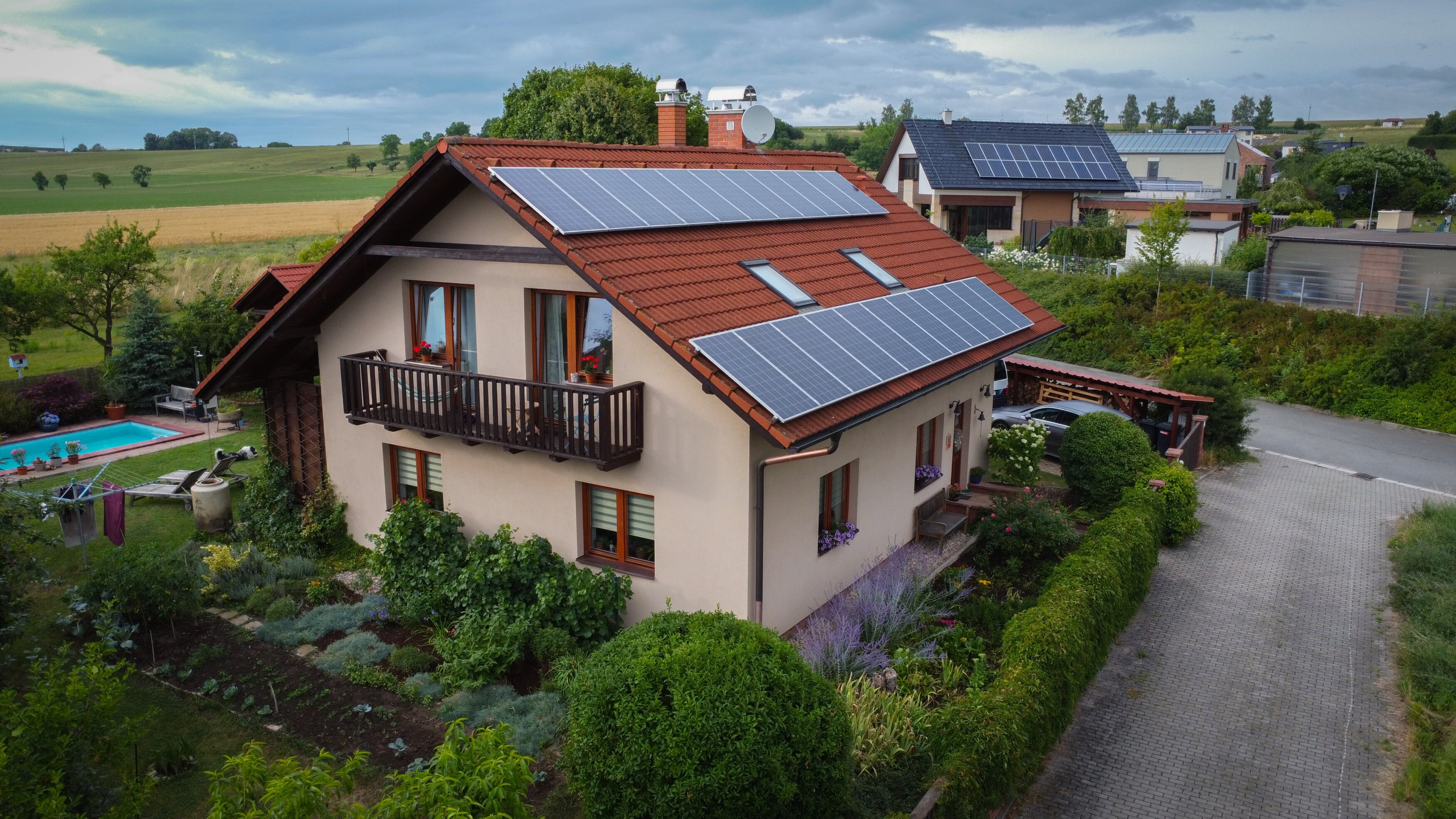 Přečtěte si, jak proměnit přebytky z FVE v přínos pro své okolí a úsporu pro sebe. Ověřte si, zda se vám vyplatí fotovoltaika s chytrým řízením s dotací až 147 000 Kč  Co znamená sdílení elektřiny? Doteď jste mohli přebytky prodávat do sítě za pár haléřů. Ale co kdybyste je mohli sdílet? Například s rodiči, sourozenci nebo sousedy a tím výrazně zlevnit účty i jim? Sdílení elektřiny znamená, že elektřina vyrobená na jednom odběrném místě (například na střeše vašeho domu) se může elektronicky převést jinam, třeba do bytu vašich prarodičů nebo na chatu. Od roku 2024 je tento princip oficiálně možný i v Česku, a to díky nové legislativě, která konečně umožňuje sdílení bez fyzického kabelového propojení. Sdílet můžete v rámci tzv. komunitního sdílení elektřiny, a to až s deseti odběrnými místy. „Majitelé FVE konečně získávají možnost rozhodnout, kam jejich přebytečná energie poputuje. Sdílení není jen o úspoře, je to krok k větší energetické svobodě. Umožňuje využít elektřinu tam, kde skutečně pomůže, a zároveň posiluje lokální energetickou stabilitu. Díky našemu systému ANNA navíc vše probíhá automaticky a přehledně, bez složitého nastavování.“ — Schlieger Představte si to jako chytrou energetickou síť mezi vámi a lidmi, kterým chcete pomoci, nebo se s nimi domluvit na férovém vyrovnání. Můžete tak využít maximum z vaší fotovoltaiky a posílit lokální soběstačnost. Chcete vědět, jak může sdílení fungovat přímo ve vaší domácnosti? Zarezervujte si nezávaznou konzultaci a společně projdeme všechny možnosti. Co by se Vám mohlo hodit: Chytré řízení fotovoltaiky: sníží vaše náklady až o 43% Co přinese komunitní energetika v roce 2025 V létě startuje sdílení elektřiny. Jak využít potenciál komunitní energetiky v Česku? Kdo může začít sdílet elektřinu? Sdílení elektřiny není jen pro technické nadšence nebo obce. Týká se každého majitele fotovoltaiky, který do sítě posílá přebytky a chce s nimi naložit chytřeji. Pokud máte doma elektrárnu, která vyrábí víc, než spotřebujete, a zároveň máte v rodině, mezi přáteli nebo sousedy někoho, kdo za elektřinu stále platí plnou cenu, můžete se do toho pustit. Na druhé straně stojí ti, kteří vlastní fotovoltaiku nemají, ale chtějí odebírat levnější elektřinu od známého, třeba od vás. Díky nové legislativě se to stává realitou. Máte vlastní fotovoltaiku a přetoky posíláte do sítě? Sdílejte elektřinu s blízkými za cenu, kterou si sami určíte. Snížíte jim účty a sobě zlepšíte návratnost investice. cta - Získat návrh systému zdarma Co je potřeba zařídit pro spuštění sdílení? Podle Energetického regulačního úřadu bylo v roce 2024 v Česku registrováno přes 44 000 nových fotovoltaických elektráren. Mnoho z nich už při instalaci počítá s budoucím sdílením přebytků v rámci rodiny, sousedství nebo komunitního projektu. Pokud i vy zvažujete sdílení vyrobené elektřiny, je dobré vědět, co vše je nutné předem připravit. Co je potřeba zařídit pro sdílení elektřiny z fotovoltaiky Založit energetické společenství nebo sdílecí skupinu – Rodina, přátelé, chataři, sousedé, kolegové. Registrovat všechna zapojená odběrná místa u OTE – Operátor trhu s elektřinou eviduje, odkud a kam energie proudí. Uzavřít smlouvu s vaším distributorem elektřiny – Sdílení je možné jen se souhlasem distributora a přesná pravidla se mohou lišit podle oblasti (Sdílení elektřiny podporují také distributoři jako ČEZ nebo E.ON.). Zajistit inteligentní řízení výroby a distribuce – Bez něj hrozí neefektivní přetoky. Systém jako ANNA od Schliegeru umí automaticky vyhodnocovat, kam poslat energii v daný moment. Jaké jsou podmínky pro sdílení elektřiny? Sdílení elektřiny není o natažení kabelu k sousedům. Aby vše probíhalo legálně a efektivně, je nutné dodržet několik zásadních podmínek, které stanoví zákon i technické možnosti: Maximálně 10 odběrných míst – tolik může být zatím členů jedné skupiny pro sdílení. Patří sem například vaše domácnost, rodiče, chata nebo sousedé. Sdílení pouze v rámci jednoho PSČ – geografické omezení zatím neumožňuje sdílet elektřinu přes města či regiony. To vše se ale chystá. Registrace všech členů u OTE – každý zapojený účastník (výrobce i příjemce) musí být registrován v Operátorovi trhu s elektřinou, který hlídá datové toky a spotřebu. Technická připravenost FVE – vaše fotovoltaická elektrárna musí být schopna sledovat výrobu i přetoky a komunikovat s distribuční sítí. Smlouva s distributorem – bez ní není možné elektřinu sdílet. Distributor zároveň určuje technické podmínky zapojení. Chytré řízení sdílení energie – zásadní roli hraje automatizace, která umožňuje řídit tok energie mezi členy podle aktuální výroby, spotřeby a předpovědi počasí. Systém jako Schlieger ANNA dokáže vyhodnocovat situaci v reálném čase a přepínat spotřebu podle toho, kde je to výhodné. Získejte ANNA řízení v ceně! Při pořízení fotovoltaiky teď od nás dostanete chytré řízení ANNA zcela zdarma. Optimalizujte spotřebu, zvyšte úspory a ovládejte energii chytře – bez příplatků. Vyberte si svou FVE a využijte limitovanou nabídku ještě dnes!  Bez chytrého řízení riskujete neefektivní využití vyrobené elektřiny, ztráty v přetocích nebo zbytečně vysoké náklady. Naopak s automatizací může být sdílení elektřiny skutečně úsporné a bezstarostné. Kolik stojí sdílení elektřiny a kdo co platí? Sdílení elektřiny přináší výrazné úspory, ale technicky a administrativně se s ním pojí dva typy nákladů: poplatek za správu systému a cena samotné elektřiny, kterou si domlouváte. 1. Poplatek za systémové napojení Za každé zapojené odběrné místo, ať už jste výrobcem nebo příjemce elektřiny, se odvádí Operátorovi trhu (OTE) 5,10 Kč měsíčně bez DPH. Tento poplatek pokrývá evidenci a přenosy dat v rámci EDC (Elektroenergetické datové centrum). Jinými slovy, i vy, jako výrobce a zároveň spotřebitel ve svém domě jste vedený jako jedno odběrné místo a poplatek 5,10 Kč se vás tedy také týká. Příklad: Pokud jako majitel FVE sdílíte elektřinu se 3 sousedy, odpovídají měsíční náklady: Vy platíte 3 × 5,10 Kč = 15,30 Kč Každý soused si připočte 5,10 Kč na svůj účet Tedy celkem 4 × 5,10 Kč = 20,40 Kč měsíčně bez DPH. 2. Cena sdílené elektřiny Tato cena se určuje v rámci skupiny podle dohody, zákon ji neupravuje. Můžete se dohodnout na symbolické částce, tržní ceně nebo ji poskytnout zdarma. Nicméně i při bezplatném přeposílání musí příjemce i tak hradit standardní distribuční tarif a daně, protože reálně proud elektřiny přechází přes distribuční síť. Neztrácejte čas pročítáním legislativy. Zorientujeme vás v nákladech i limitech sdílení. Pomůžeme vám s registrací a nastavením systému. Jak funguje inteligentní řízení sdílení elektřiny? Sdílení elektřiny naplno využijete teprve tehdy, když přesně víte, kolik vyrábíte, co spotřebováváte a kam proudí přebytky.A právě v tom má Schlieger náskok: inteligentní systém ANNA umí řídit celý tok energie v reálném čase – a bez nutnosti neustálého zásahu majitele. ANNA hlídá výrobu, spotřebu i přetoky, a v případě přebytku sama rozhodne, kdy aktivovat domácí spotřebiče nebo nasměrovat energii ke konkrétnímu odběrateli. Optimalizuje spotřebu v čase, což vede ke snížení nákladů i zátěže sítě. Skrze přehlednou aplikaci získáte přístup ke všem důležitým datům: jaká je aktuální výroba, kolik energie zůstává doma a co odchází do komunity. Výhodou je i technologická připravenost na další změny v legislativě. Jakmile stát umožní sdílení přes více PSČ nebo přidá nové modely komunitní energetiky, ANNA bude připravena – a vy s ní. „Sdílení otevírá cestu k větším úsporám, lepšímu využití vlastní výroby a férovému rozdělení energie v rámci rodiny nebo sousedské komunity. Právě proto jsme systém Schlieger ANNA připravili tak, aby na sdílení uměl chytře reagovat a co nejvíc z něj vytěžit.“ — Schlieger Chcete mít přehled o každé kilowatthodině? Se systémem Schlieger ANNA řídíte výrobu i přetoky naprosto efektivně.  Optimalizuje spotřebu energie z fotovoltaiky tak, aby přinášela maximální užitek a zkrátila dobu návratnosti. Jak může sdílení elektřiny zvýšit návratnost vaší fotovoltaiky? Každá domácnost s vlastní FVE zná situaci, kdy elektřinu vyrobí, ale nedokáže ji plně spotřebovat. Část výroby tak odchází do sítě prakticky bez užitku. Sdílením elektřiny se tento scénář mění – přebytky už nejsou ztracenou hodnotou, ale konkrétním přínosem pro další členy vaší komunity. Díky nové legislativě můžete energii předávat rodině, sousedům nebo známým a stanovit si vlastní podmínky – včetně ceny. Sdílení tak funguje jako férová výměna: vám se zvyšuje návratnost investice, příjemci zase klesají účty za elektřinu. Navíc posilujete lokální soběstačnost, snižujete závislost na tradičních dodavatelích a vytváříte udržitelnější model fungování celé čtvrti nebo rodinného klanu. To vše bez potřeby složité administrativy nebo zásahu do stávající FVE. „Každá sdílená kilowatthodina se počítá. Pro vás jako investora i pro komunitu, která z toho těží.“ – energetický analytik, interní tým Schlieger Chcete využít maximum ze své fotovoltaiky? Začněte sdílet elektřinu a zapojte do systému i své blízké. Naše fotovoltaika připravená na sdílení! Sdílení elektřiny vám dává možnost využít vlastní fotovoltaiku naplno. Místo přetoků za pár haléřů pomůžete svým blízkým, zlepšíte návratnost celé investice a udržíte vyrobenou energii tam, kde má skutečný dopad. Se systémem Schlieger ANNA navíc přesně víte, kam elektřina míří, kdo ji využívá a kolik vám to reálně přináší. Schlieger recenze: očima našich zákazníků ⭐⭐⭐⭐⭐ Navrhneme vám FVE, která je na sdílení připravená od prvního dne. Pomůžeme vám s registrací do systému OTE, nastavíme řízení spotřeby i přetoků a ukážeme, jak vše sledovat jednoduše v aplikaci.